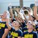 Members of the Michigan Marching Band wave to people on their hotel balcony as they goof around during a break from warm ups before performing during beach day in Clearwater, Fla. on Sunday, Dec. 30. Melanie Maxwell I AnnArbor.com